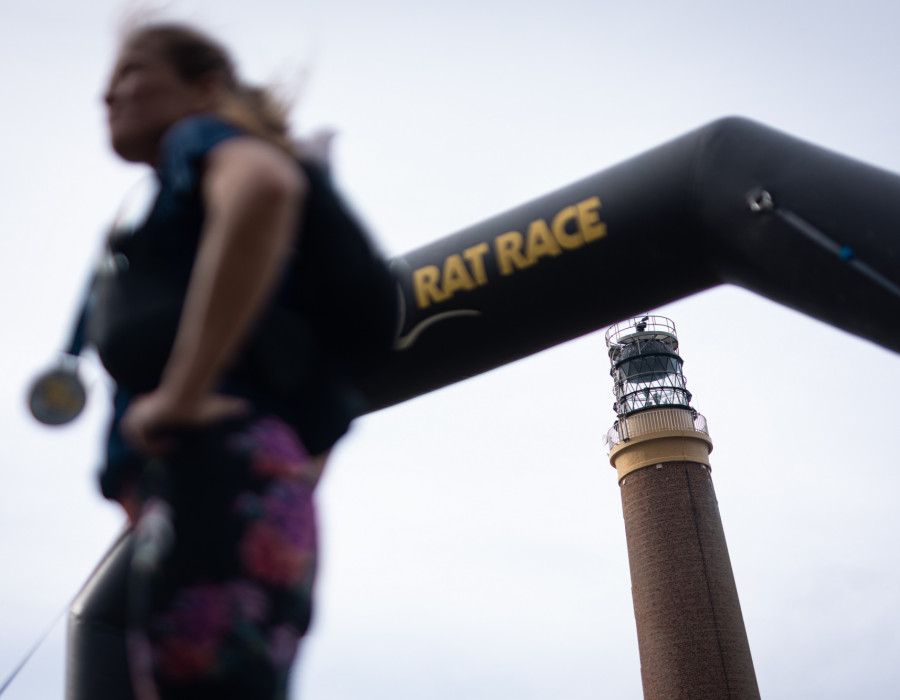 Woman stood at finish with medal around her neck