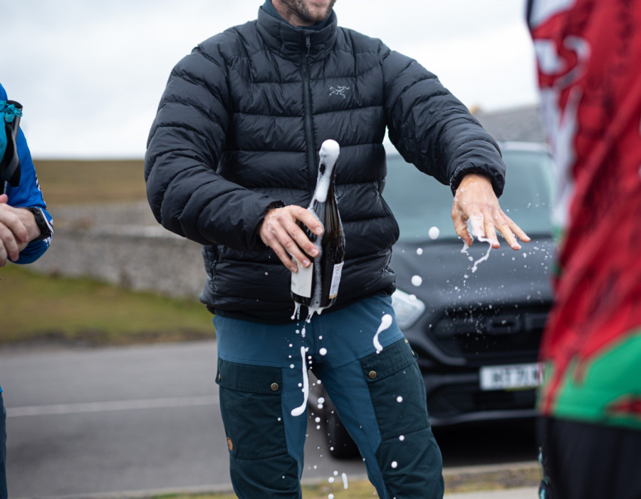 Man opening bottle and smiling