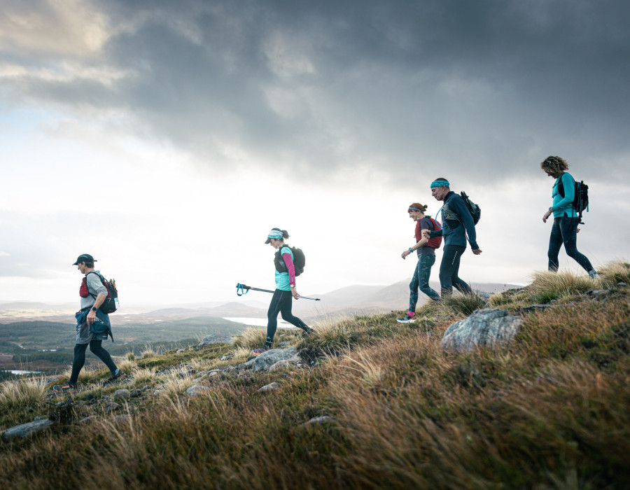 People walking down a grassy hill