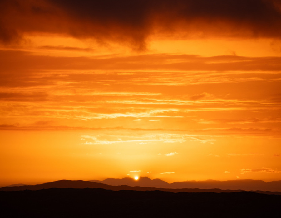 Dark hills and colourful sky