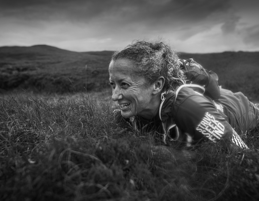 Woman smiling and lying on grass