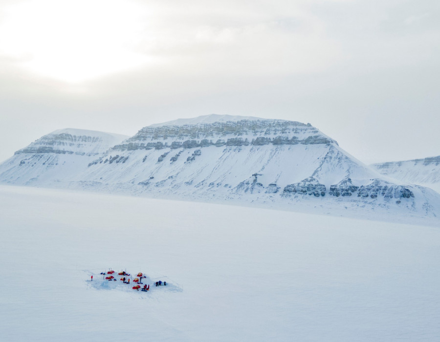 Tents pitched in white snow-covered landscape