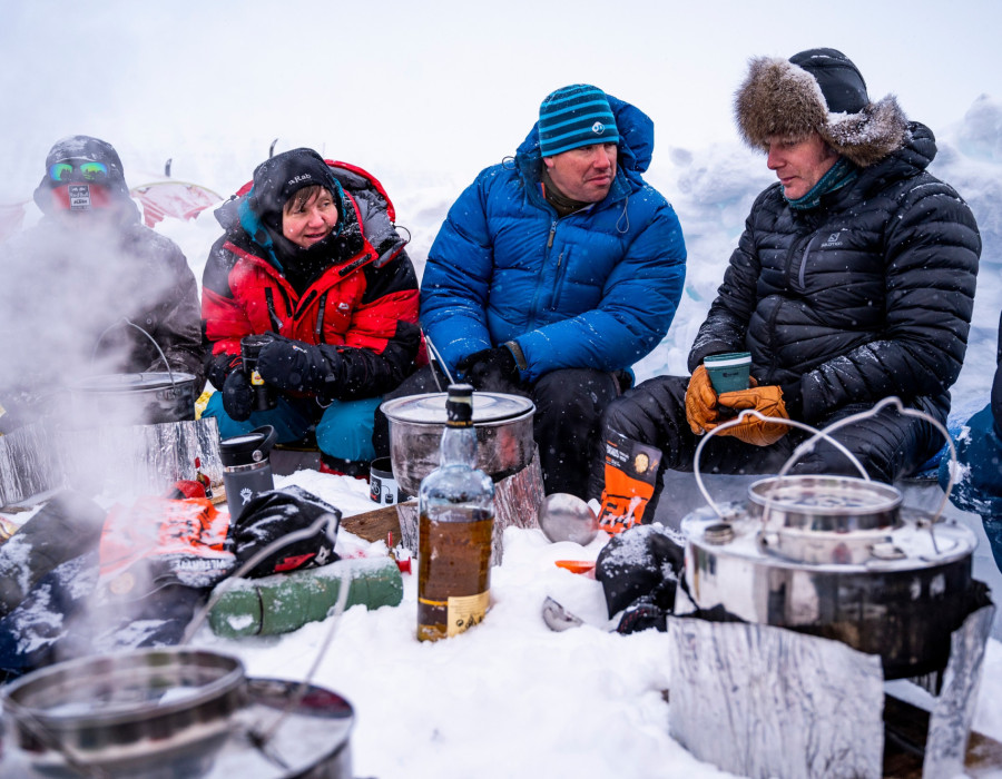 Participants sat in snow and gathered around cooking stoves