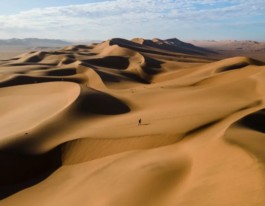 Smooth sand dunes under clear sky