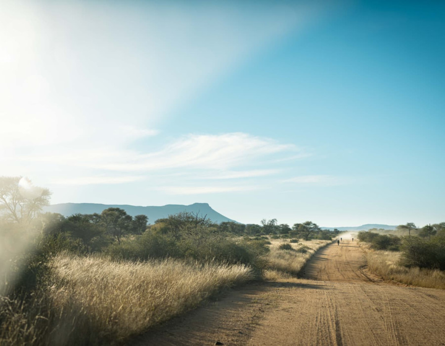 Dust road with cyclists in the distance