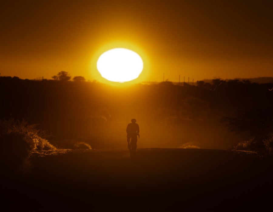 Silhouette of cyclist with the sun behind
