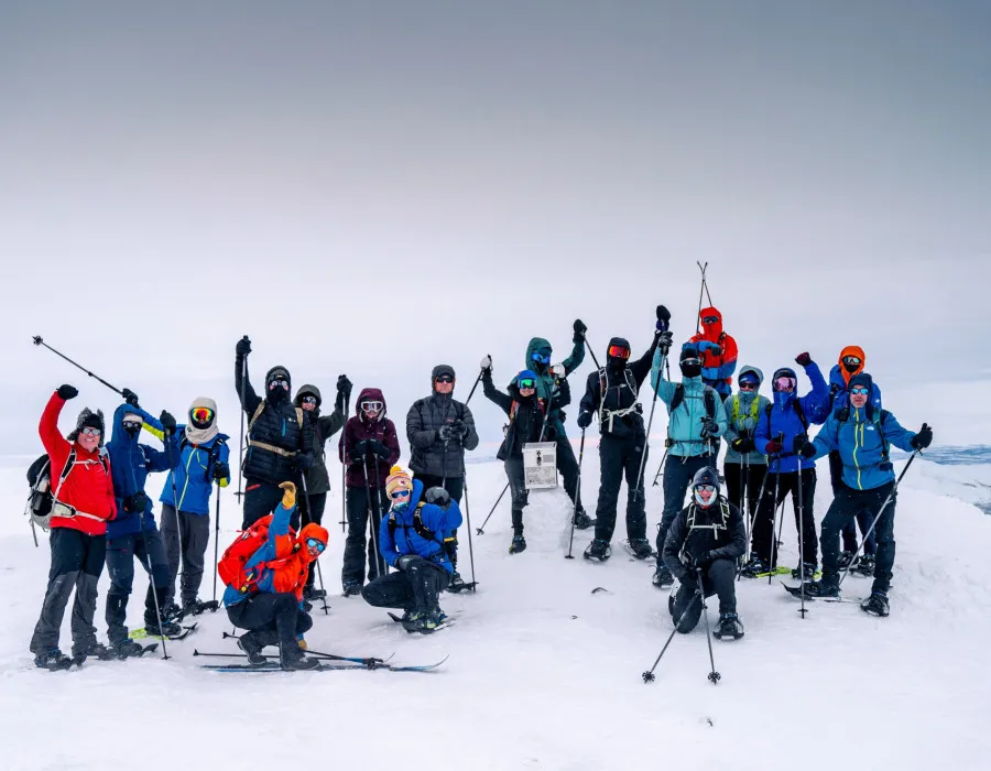 A group of event participants with skis who are cheering