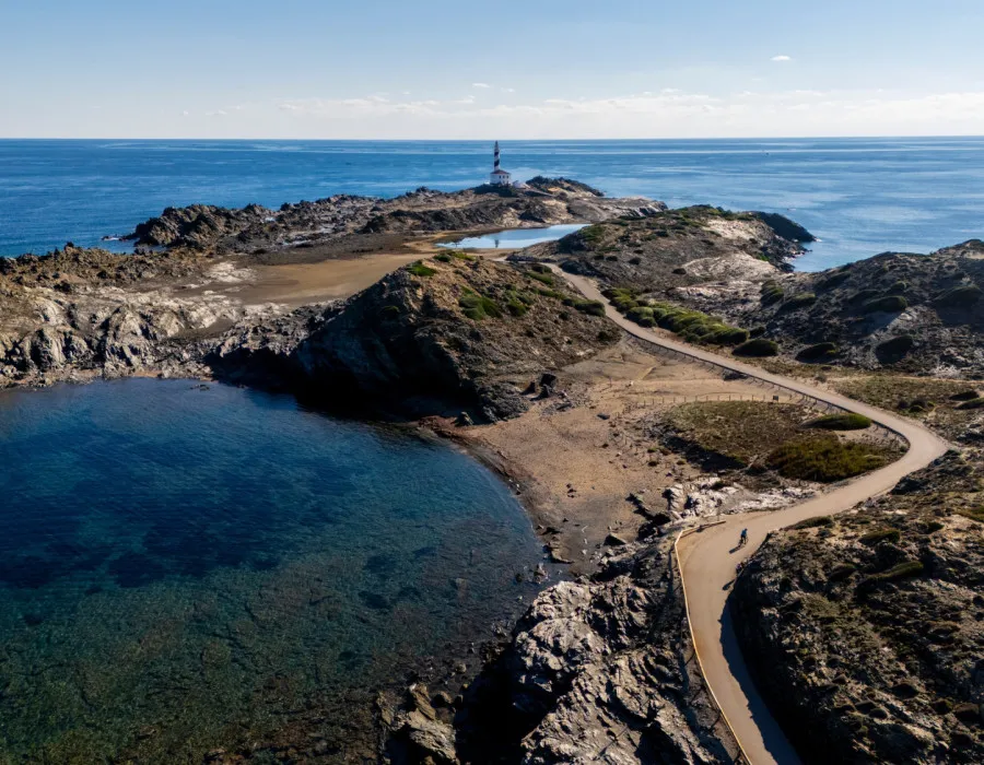 Road through rocky terrain with sea either side