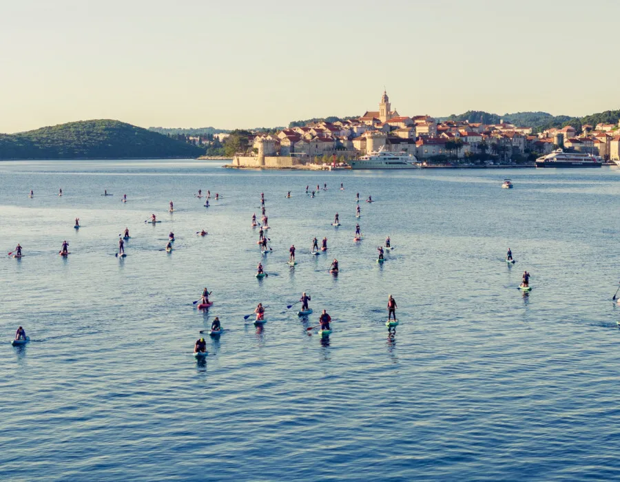 Event participants SUP across open water to Orebic