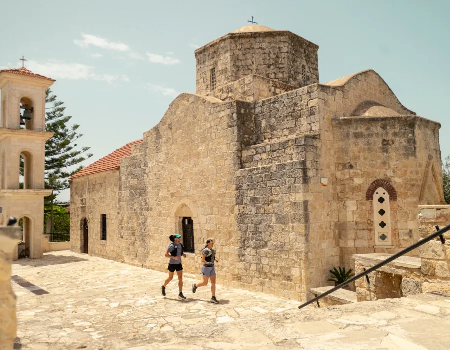 Man and woman running past an old church