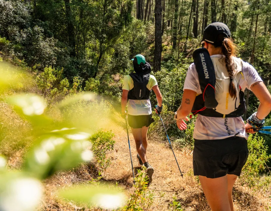 Two participants running through a forest