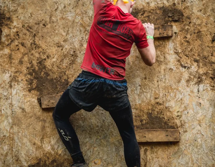 Man climbing up a wooden board