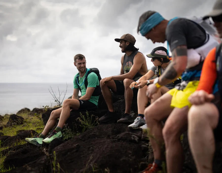 Group of participants, sitting on rocks and talking and laughing