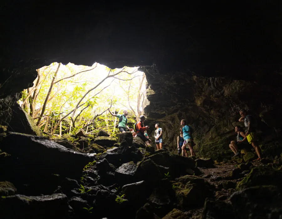 Event participants standing and sitting in a cave