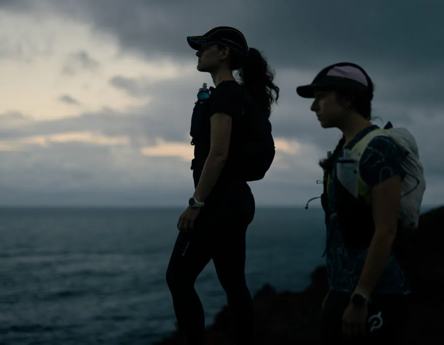Women looking out onto dark sea and sky