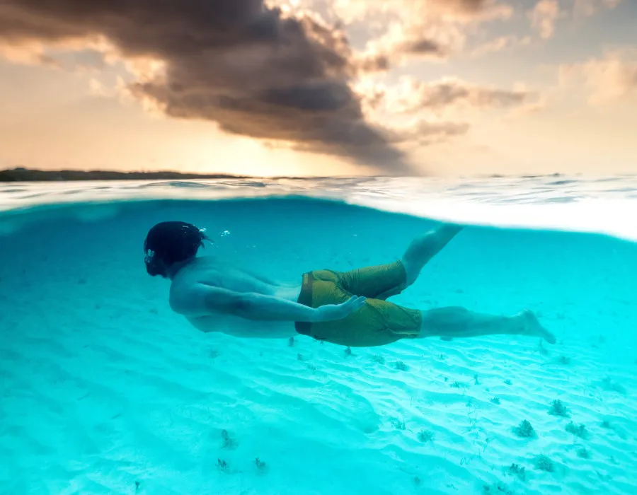 Man snorkelling through clear water