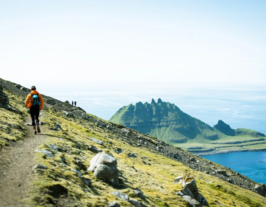 Participant running along a rocky, coastal track