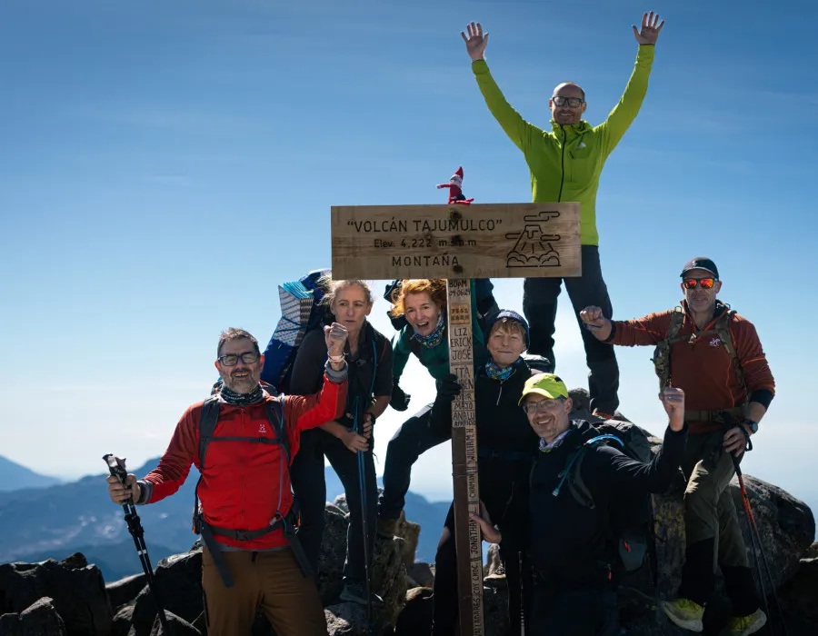 Participants stood with volcano sign