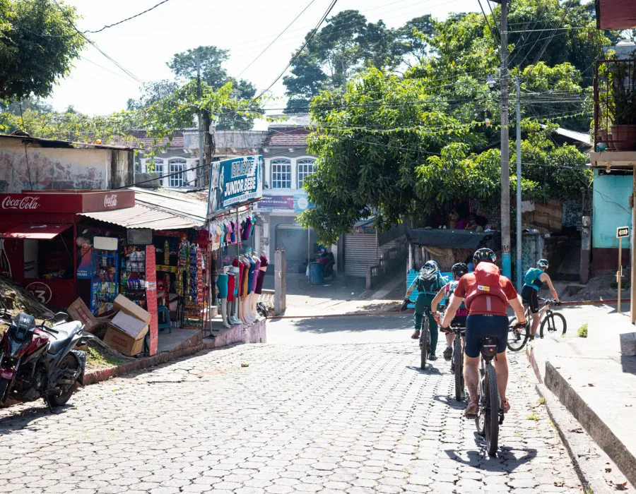Participants cycling through sunny, colourful town