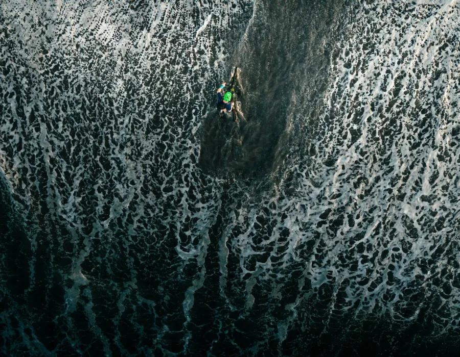 Aerial view man wading through water