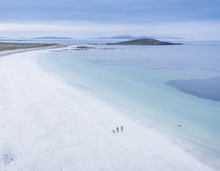 Aerial view of sandy coastline and clear water