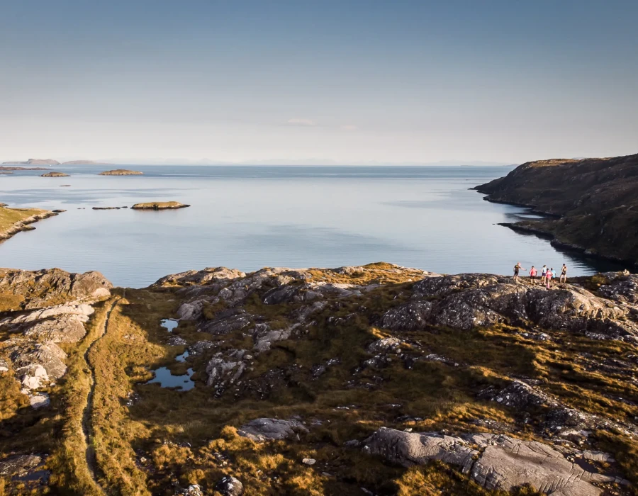 Participants stood on rocky terrain, looking out to clear, still water