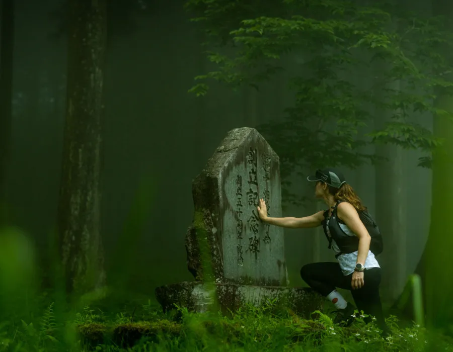 Woman touching a sign in a dense forest