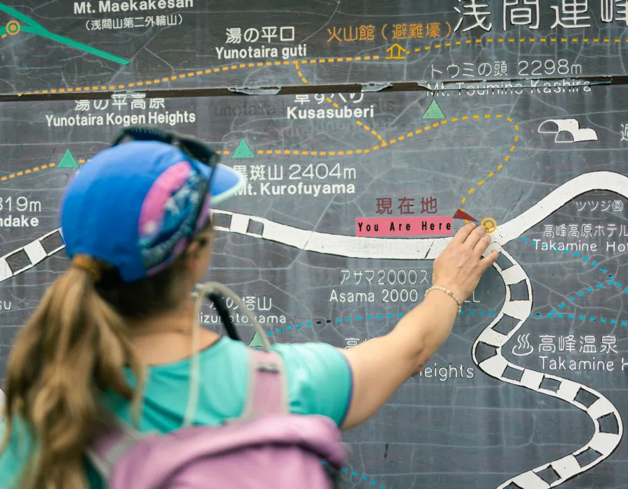 Woman pointing to where they currently are on map