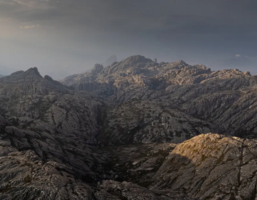 Grey sky with rocky mountains below