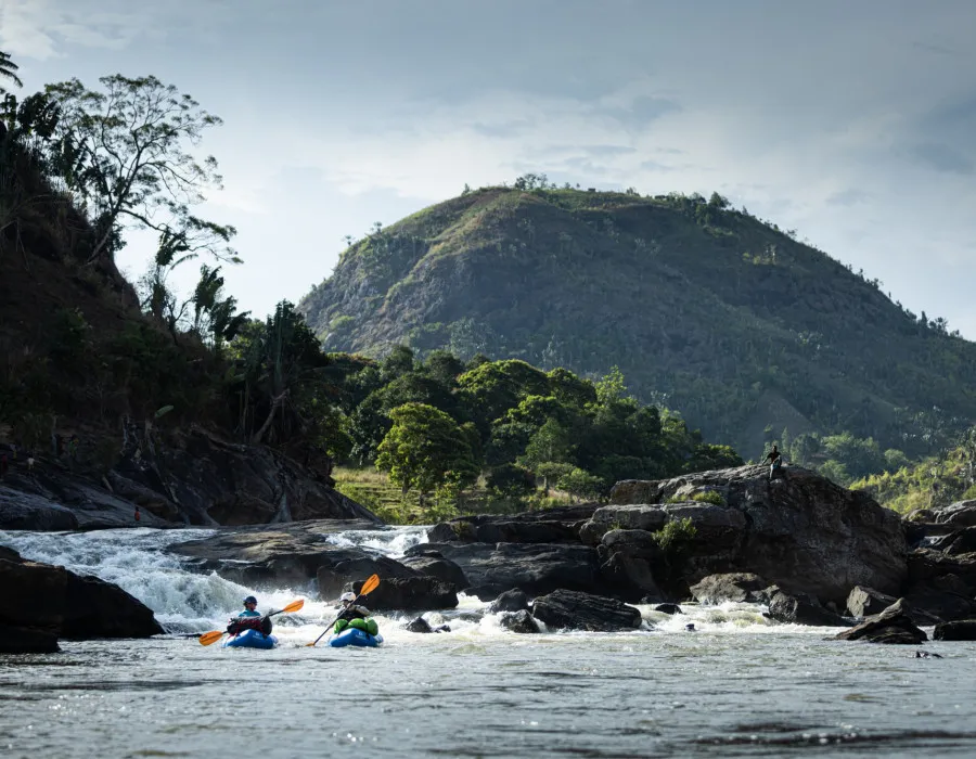 Participants rafting with mountain behind