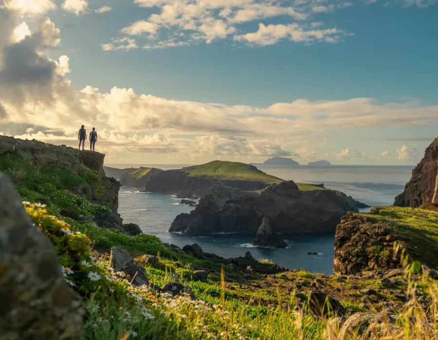 Two participants looking out onto rocky islands and sea
