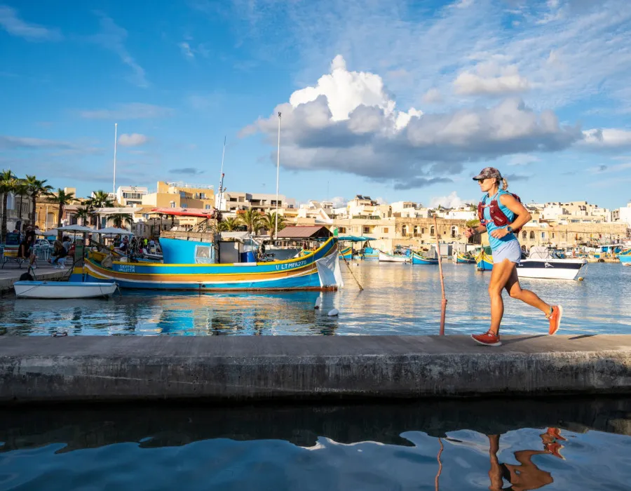 Woman running past boats