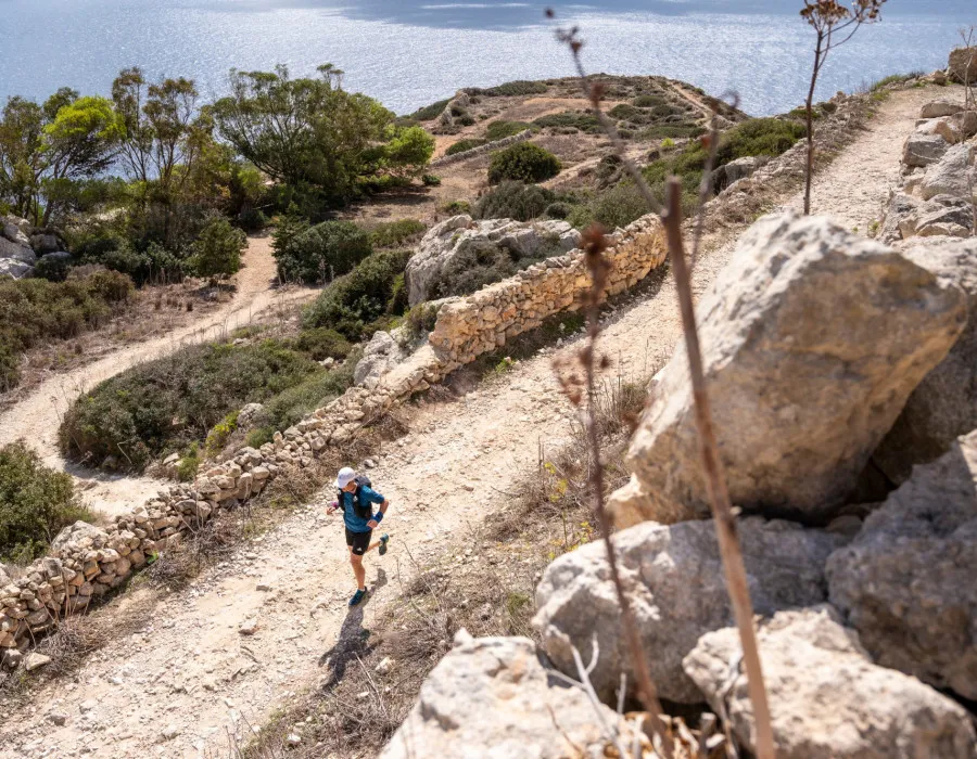 Participant running along dusty path in sunshine