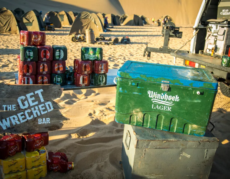 Piles of canned drink infront of tents