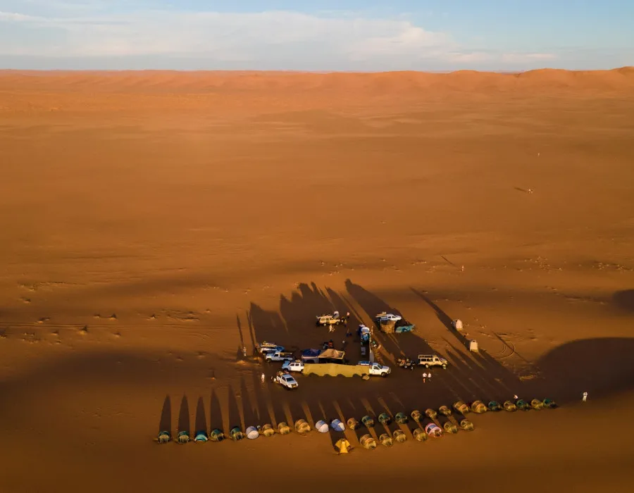 Aerial view of cars and tents in desert