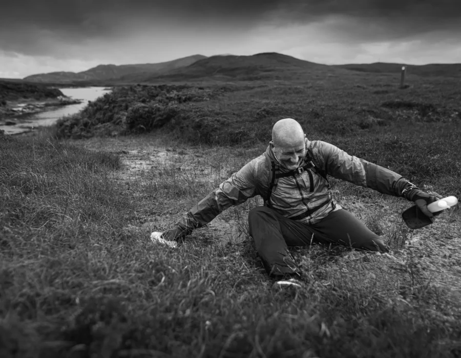 Man in boggy, muddy terrain