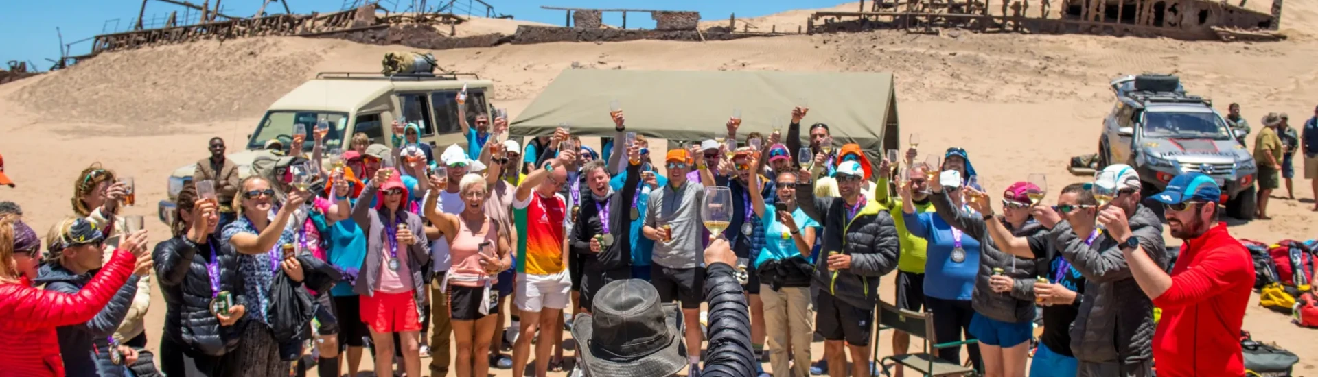 Participants gathered around a man raising a glass of wine