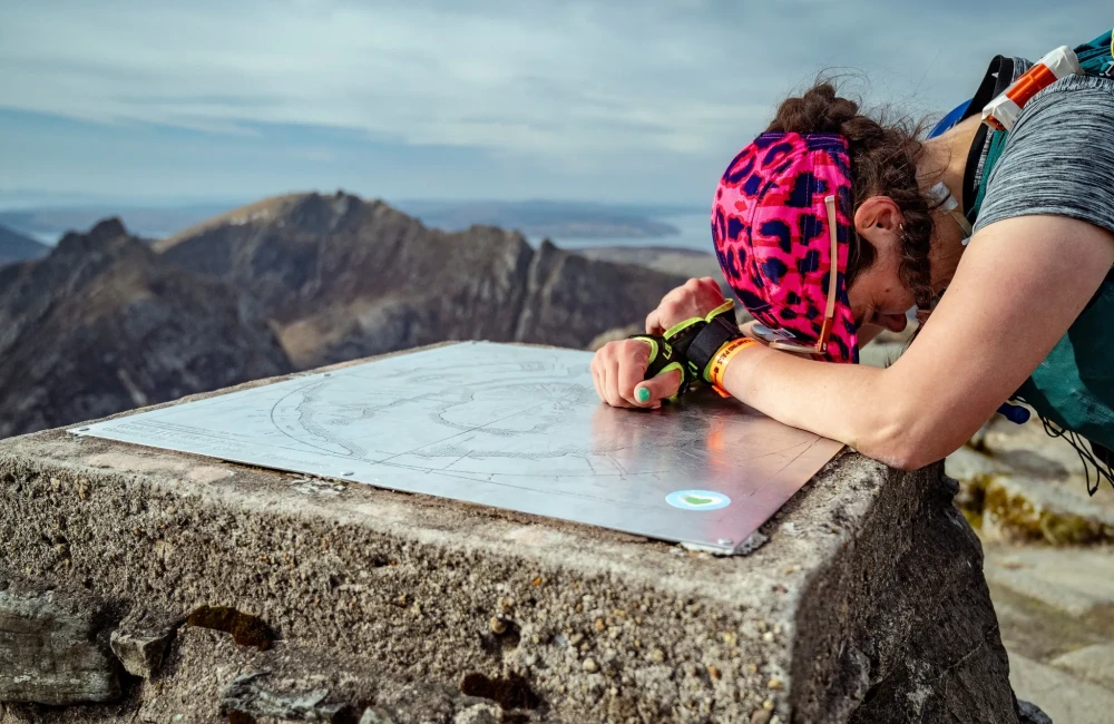 Woman resting at top of mountain