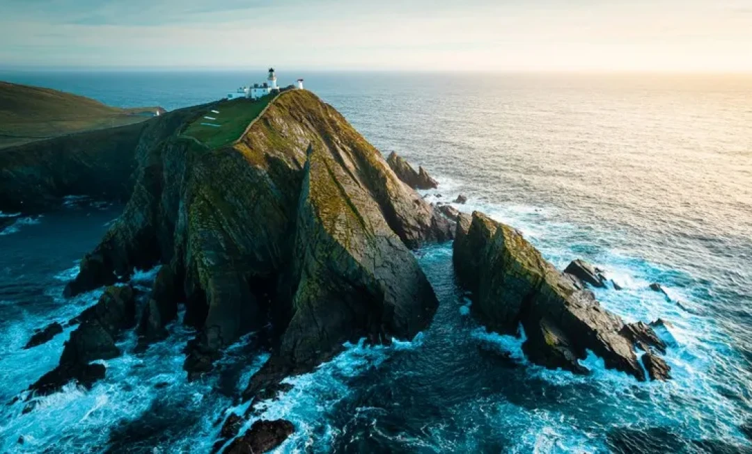 Aerial view of buildings on cliff and water below