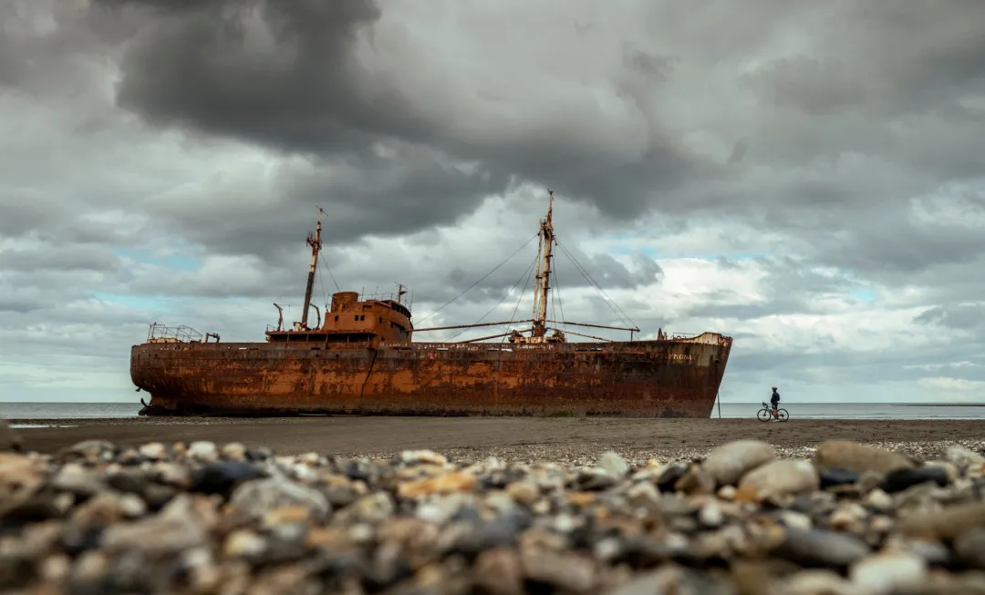 Cyclist stopping to look at shipwreck