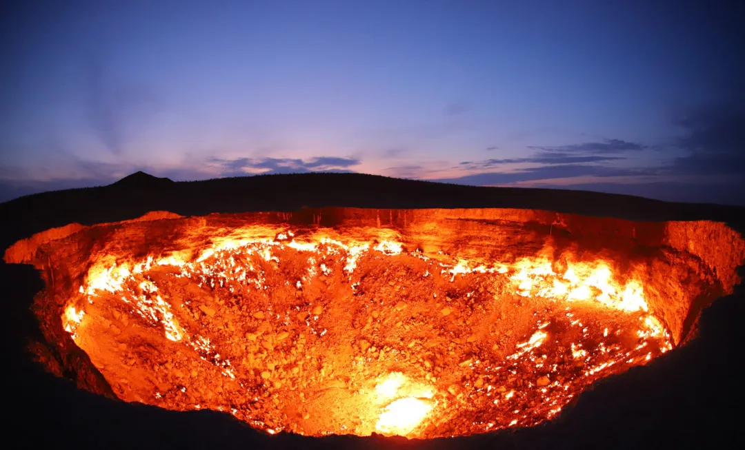 Crater in ground on fire