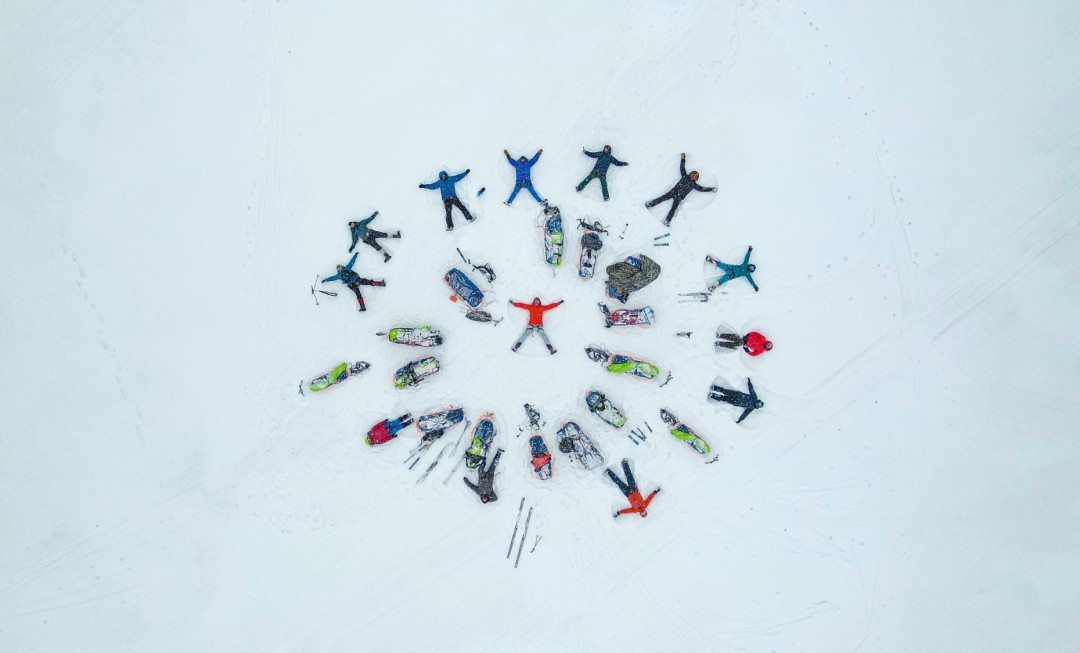 Participants lying in a circle in the snow