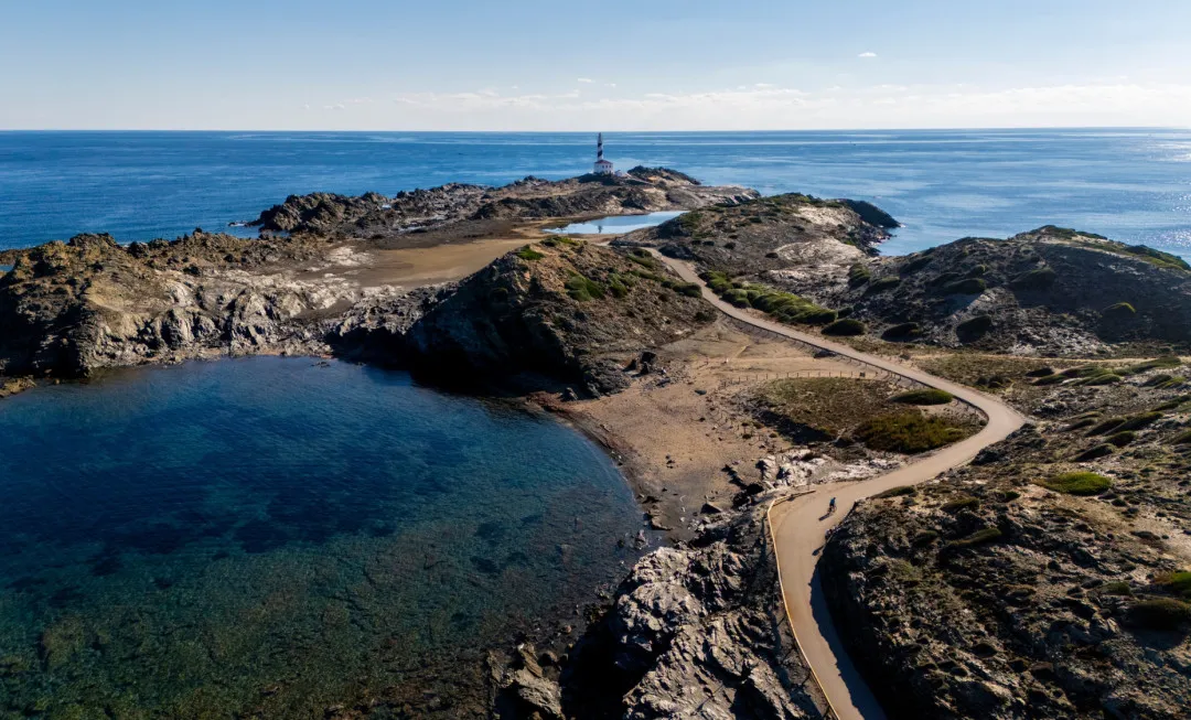 Road through rocky terrain with sea either side