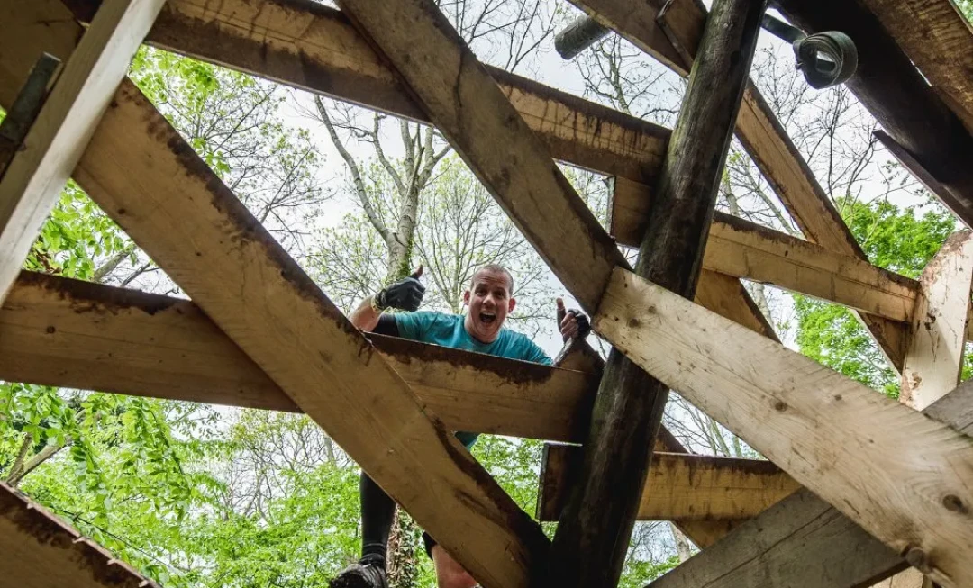 Man, putting his thumbs up and standing on wooden planks