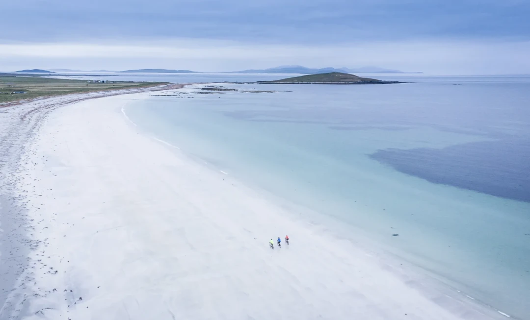 Aerial view of sandy coastline and clear water