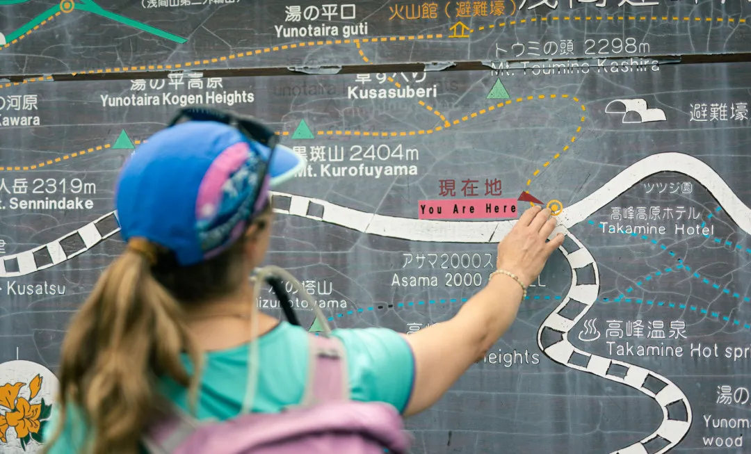 Woman pointing to where they currently are on map