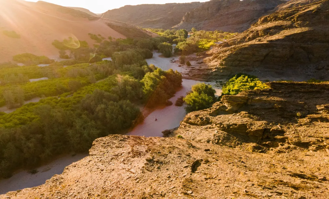 River travelling through greenery and rocky terrain