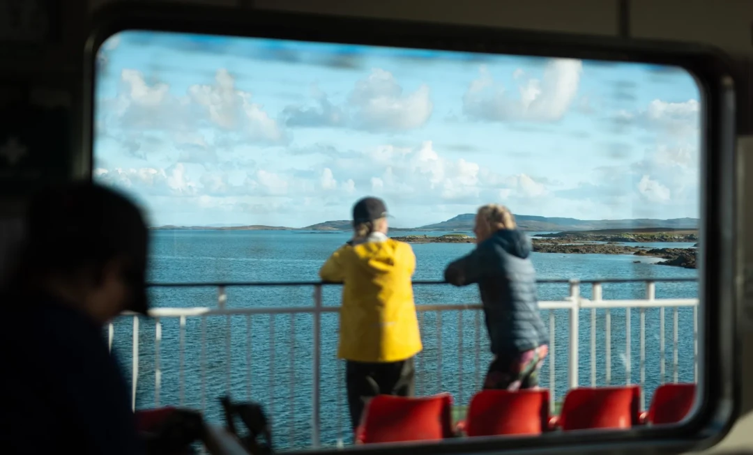 People looking out across water