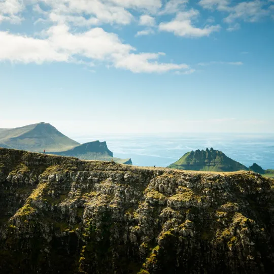 Rocky mountains and cliffs with clear water in the distance