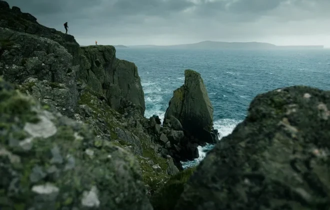 Participants stood on rocky cliffs with water below